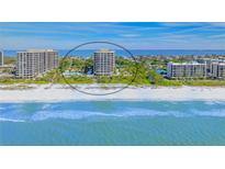 Aerial view of beachfront condo building with private beach access and stunning Gulf views at 1211 Gulf Of Mexico Dr # 704, Longboat Key, FL 34228