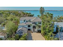 Beautiful waterfront home with lush tropical landscaping, multi-car garage and a grand staircase entrance at 1540 Hillview Dr, Sarasota, FL 34239