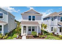 Charming two-story home with manicured lawn and inviting front porch at 164 Eagleston Ln, Sarasota, FL 34240