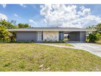 Charming single-story home with stone accents and a well-maintained lawn at 22209 Breezeswept Ave, Port Charlotte, FL 33952