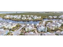 Beautiful waterfront community featuring colorful two-story homes, lush landscaping, and a tranquil waterway at 319 Compass Point Dr # 201, Bradenton, FL 34209