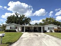 Charming single-story home featuring a covered carport and a well-maintained front lawn at 3321 Fuller St # 105, Sarasota, FL 34231