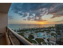 Stunning sunset view from balcony overlooking the beach, pool and manicured grounds at 535 Sanctuary Dr # A602, Longboat Key, FL 34228