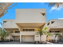 Unique and modern exterior elevation showcases a two-story home with neutral siding and manicured landscaping at 548 Beach Rd # 540A, Sarasota, FL 34242