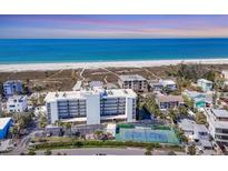 Breathtaking aerial view of beachfront condo, white sands, blue waters, and community tennis courts at 625 Beach Rd # 207, Sarasota, FL 34242