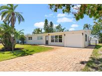 Charming single-story home with brick driveway and well-manicured lawn at 6732 Washington Pl, Bradenton, FL 34207