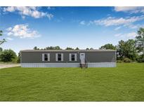 Charming single-story home featuring a well-maintained lawn and classic design elements at 8414 Sweden Blvd, Punta Gorda, FL 33982