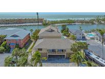 Waterfront home with a pool featuring stunning ocean views and lush tropical landscaping at 9034 Midnight Pass Rd # 6, Sarasota, FL 34242