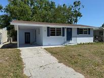 Single-story home with a covered front porch, driveway, and well-maintained lawn at 1220 12Th W Ave, Palmetto, FL 34221