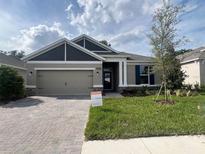 Beautiful single-story home with a brick paver driveway and manicured lawn at 19575 Fort King Run, Brooksville, FL 34601