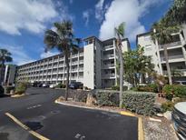 Exterior view of a condo complex showing multiple balconies, palm trees and well-maintained landscaping at 3368 Lake Bayshore Dr # 217 Building P, Bradenton, FL 34205