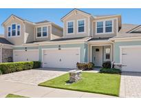 Charming townhome featuring a well-manicured lawn, a brick driveway, and an attached garage at 3623 Pitch Ln, Sarasota, FL 34232