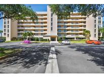 Beautiful exterior shot of multi-story condo building with manicured grounds and ample parking at 4460 Fairways Blvd #604 Blvd # 604, Bradenton, FL 34209