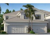 Charming two-story home featuring a spacious two-car garage, palm trees, and well-maintained landscaping at 5616 Summit Pointe Cir # 101, Bradenton, FL 34210