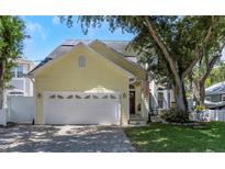 Charming two-story home with a well-maintained lawn and a two-car garage at 6015 S Elkins Ave, Tampa, FL 33611