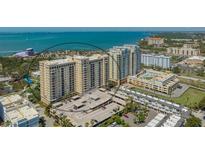 Stunning aerial view of high-rise condos with waterfront views, parking, and meticulous landscaping at 750 N Tamiami Trl # 304, Sarasota, FL 34236
