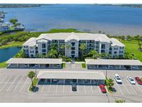 Aerial view of condos near the water, with covered parking and beautifully maintained landscaping at 850 Tidewater Shores Loop # 202, Bradenton, FL 34208