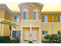 Inviting condo exterior featuring a vibrant color scheme and well-maintained landscaping at 12971 Tigers Eye Dr, Venice, FL 34292