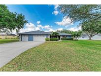 Charming single-story home with a well-maintained lawn and a three-car garage at 13615 4Th Ne Ave, Bradenton, FL 34212