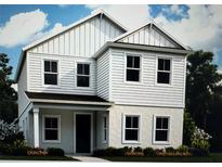 Charming two-story home featuring vertical siding, multiple windows, and a welcoming front porch at 141 Thorne Ln, Sarasota, FL 34240