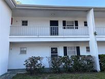 Charming two-story condo with a clean white exterior and decorative shrubs at 205 46Th Avenue W Ter # 425, Bradenton, FL 34207
