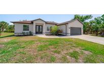 Charming one-story home with well-maintained landscaping and a two-car garage at 2366 Ann Arbor Rd, North Port, FL 34286