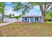 Charming single-story home with a blue exterior, metal roof, and well-manicured landscaping at 2715 52Nd Avenue W Ter, Bradenton, FL 34207
