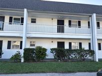 Charming two-story condo with black shutters, white railings, and well-maintained landscaping at 4502 3Rd Street W Cir # 242, Bradenton, FL 34207