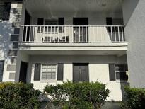 Charming condo exterior with balcony, black shutters, and lush landscaping at 4505 3Rd Street W Cir # 269, Bradenton, FL 34207