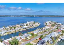 Aerial view of a waterfront property showing its location in a scenic coastal neighborhood with beautiful water views at 4911 Commonwealth Rd, Palmetto, FL 34221