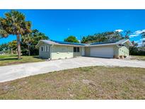 Charming single-story home with an attached garage, solar panels, and a spacious driveway at 510 S Venice Blvd, Venice, FL 34293