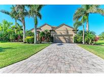 Charming one-story home showcasing a paver driveway and a meticulously maintained lawn at 618 148Th Ne Ct, Bradenton, FL 34212
