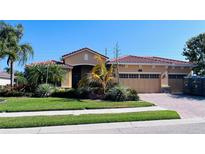 Charming single-story home with a well-maintained lawn and lush landscaping at 6600 Horned Owl Pl, Sarasota, FL 34241