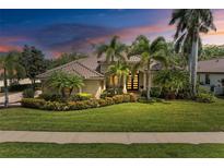 Charming single-story home with lush landscaping and a well-manicured lawn, showcasing curb appeal at 7913 Osprey Hammock Ct, Sarasota, FL 34240