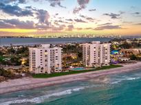 Stunning beachfront condos featuring a shared pool and beautiful coastal views with city skyline in the distance at 1050 Longboat Club Road # 903, Longboat Key, FL 34228