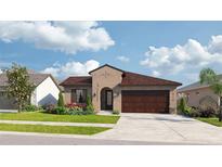 Charming single-story home featuring a well-manicured lawn, complemented by colorful flowerbeds and a spacious two-car garage at 11826 Moonsail Dr, Parrish, FL 34219