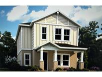 Charming two-story home with neutral siding, decorative shingles, covered porch, and manicured landscaping at 149 Thorne Ln, Sarasota, FL 34240