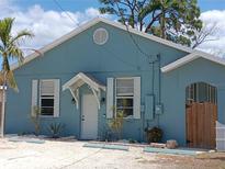 Charming blue exterior with white trim, complemented by a well-manicured yard and inviting front entrance at 1609 17Th W St, Bradenton, FL 34205
