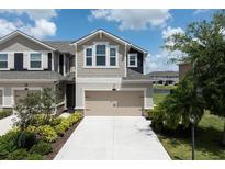 Townhome exterior with a two-car garage and manicured landscaping at 5543 Pleasantview Ct, Bradenton, FL 34211