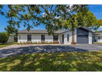 Charming single story home with a well manicured front yard and black windows at 5704 2Nd Avenue Nw Dr, Bradenton, FL 34209