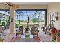 Relaxing screened-in patio boasts brick pavers, comfortable seating, and scenic golf course views at 6642 Oakland Hills Dr, Lakewood Ranch, FL 34202