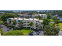 Beautiful condominiums featuring multiple stories, lush landscaping, and a serene lakeside setting at 825 S Osprey Ave # 302, Sarasota, FL 34236