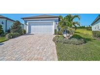 Beautiful single-Gathering home with a paver driveway, two-car garage and well manicured landscaping at 8313 Ocean Tides Cv, Parrish, FL 34219