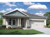 Charming single-story home featuring a welcoming front porch, two-car garage, and beautifully landscaped front yard at 19669 Fort King Run, Brooksville, FL 34601