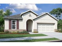 Charming single-story home featuring a stucco facade, arched entryway, two-car garage, and manicured front lawn at 19679 Fort King Run, Brooksville, FL 34601