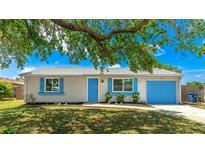 Charming single-story home with a well-maintained lawn, blue shutters, and a matching blue garage door at 2237 Lockwood Meadows Cir, Sarasota, FL 34234