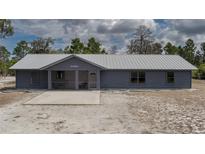Charming single-story home featuring a metal roof, covered porch and xeriscaped front yard at 31860 Taylor Grade Rd, Duette, FL 34219