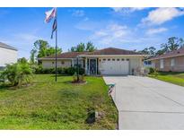 Charming single-story home featuring a well-maintained lawn and a two-car garage at 3459 Lotus Rd, North Port, FL 34291