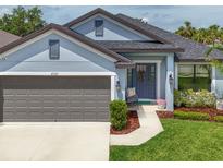 Charming single-Gathering home with a manicured lawn, gray exterior, and a two-car garage providing a welcoming curb appeal at 4509 95Th E Ter, Parrish, FL 34219