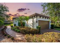 Charming single-story home with a two-car garage, lovely landscaping, and a brick walkway at 4704 Stafford Ct, Palmetto, FL 34221
